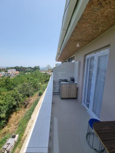 a balcony with a table and chairs on a house at Becic Apartments in Ulcinj