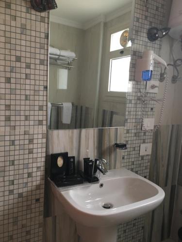 伊斯梅利亞的住宿－Tolip El Fairouz Hotel，一间带水槽和镜子的浴室