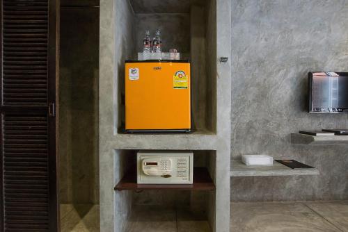 a yellow appliance sitting on a wall in a room at Buddy Boutique Inn in Bangkok