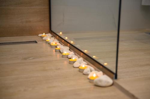 a row of shoes lined up on a floor with lights at KORINA APART HOTEL KAVOS in Kavos