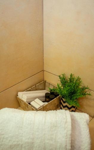 a corner of a bathroom with a toilet and a plant at Amphithea Fragokastelo-Skaloti in Skalotí