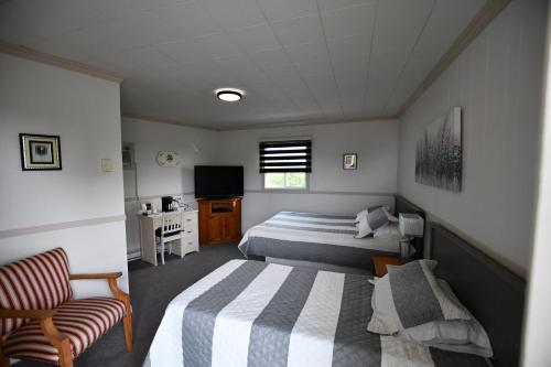Motel Riviere Trois Pistoles tesisinde bir odada yatak veya yataklar