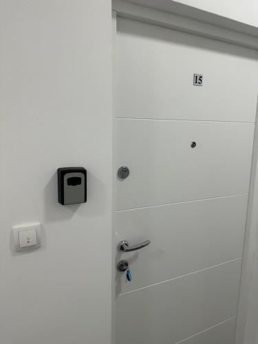 a white door with a tv on top of it at Ušće in Valjevo