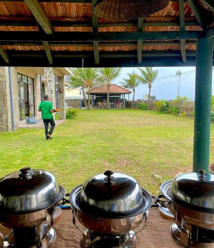 a group of pots sitting on top of a gas grill at Spice of Ceylon in Chilaw