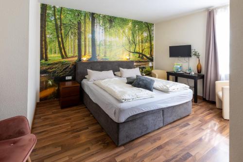 Schlafzimmer mit einem Bett mit Wandgemälde in der Unterkunft Flair Hotel Hopfengarten in Miltenberg