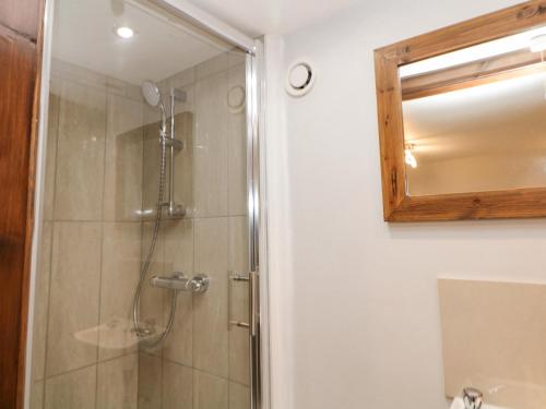 a bathroom with a shower and a mirror at Querc in Stony Middleton
