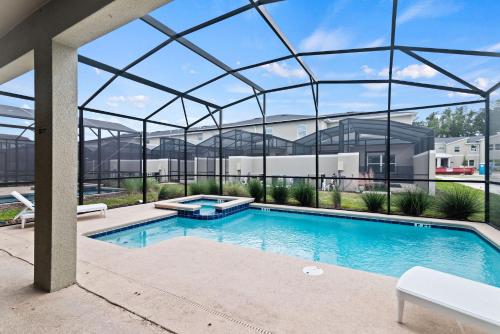 a swimming pool in a building with a glass roof at Magical Themed Home - Disney 15 min in Kissimmee