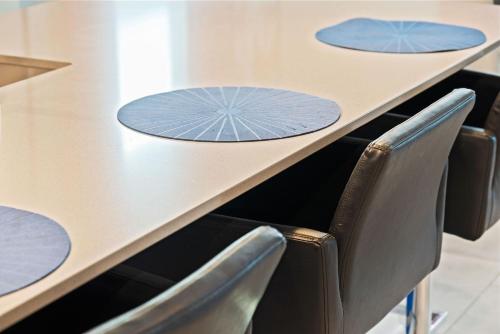 a row of chairs around a table with blue circles on it at Magical Themed Home - Disney 15 min in Kissimmee