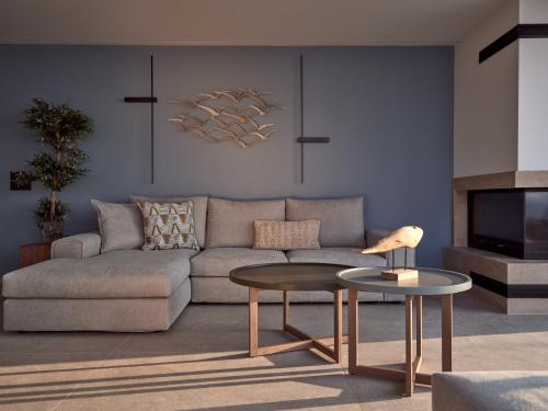 a living room with a couch and a table at Bardo Villa, Endless Blue with Heated Pool, By ThinkVilla in Argasi
