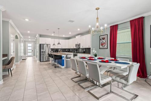 a kitchen and dining room with a table and chairs at Magical Themed Home - Disney 15 min in Kissimmee