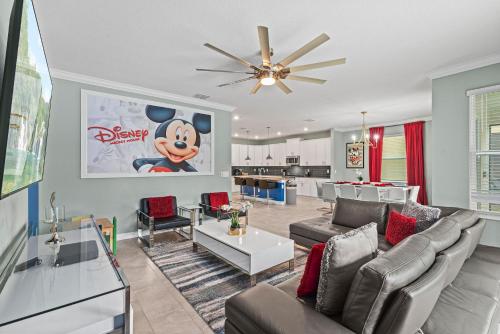 a living room with couches and a dining room at Magical Themed Home - Disney 15 min in Kissimmee