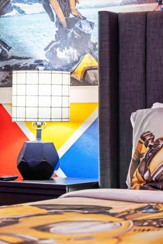 a bedroom with a bed and a table with a lamp at Magical Themed Home - Disney 15 min in Kissimmee