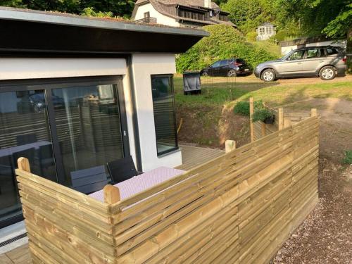 a wooden privacy fence in front of a house at Lovely guest house close to the sea and forest! in Domsten