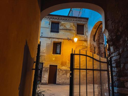 an archway with a gate in front of a building at Relais nel Castello in Bassano del Grappa