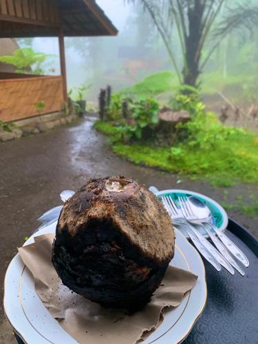 a cake sitting on a plate on a table at The Alam Bungalow & Restaurant in Tetebatu