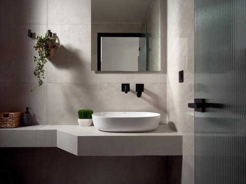 a bathroom with a white sink and a mirror at Bardo Villa, Endless Blue with Heated Pool, By ThinkVilla in Argasi