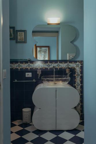 a bathroom with a sink and a mirror at Casa Caracciolo in Pitigliano
