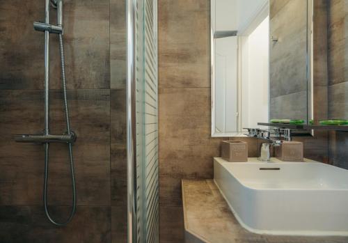 a bathroom with a white sink and a mirror at Erifili Houses in Faros