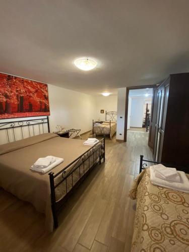 a hotel room with two beds and a mirror at La Casa del Borgo-intero appartamento in Latina