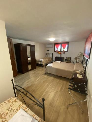 a large bedroom with a bed and a living room at La Casa del Borgo-intero appartamento in Latina