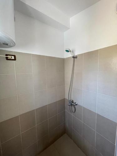 a shower in a tiled bathroom with a shower head at House for rent Jurgen in Golem