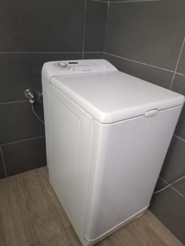 a white toilet in a bathroom next to a wall at House Of Diamond in Kírra