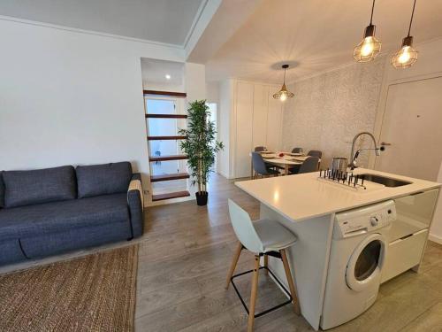 a kitchen and living room with a couch and a table at Ria Sol Mar Apartment Costa Nova in Costa Nova