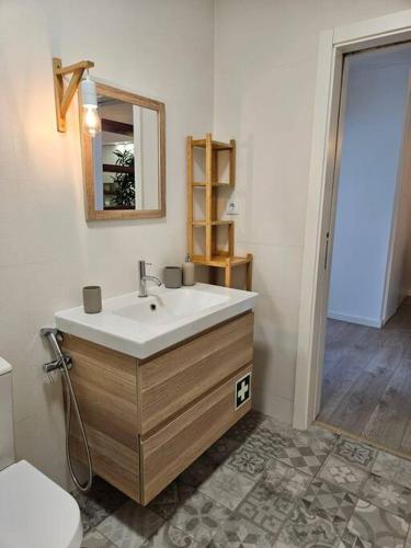 a bathroom with a sink and a toilet at Ria Sol Mar Apartment Costa Nova in Costa Nova