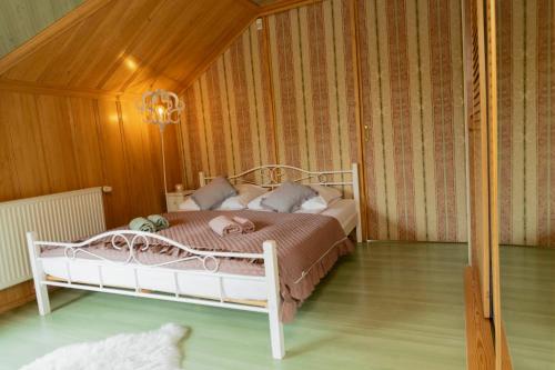 a bedroom with a white bed in a room at Willa Chruślice-Basen sezon,Sauna in Nowy Sącz