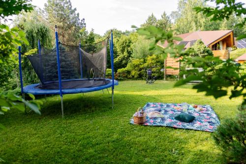 a blue trampoline in a yard with a blanket at Willa Chruślice-Basen sezon,Sauna in Nowy Sącz