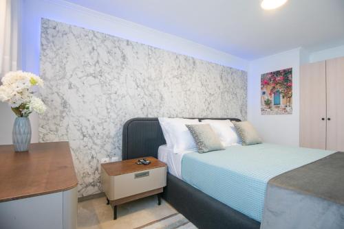 a bedroom with a bed and a vase of flowers at Solomon Premium House in Kritsá