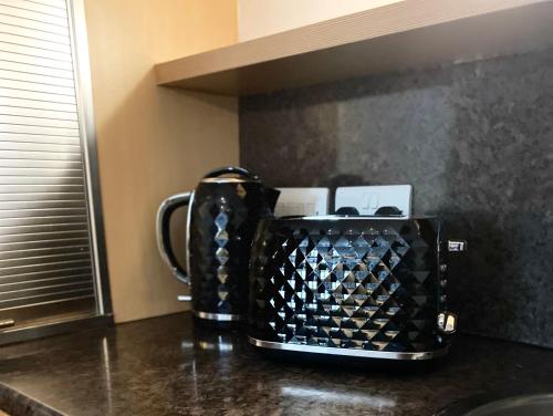 a coffee maker sitting on top of a kitchen counter at St James’ Blvd Newcastle Apartment in Newcastle upon Tyne