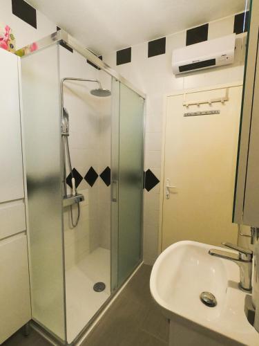 a bathroom with a glass shower and a sink at Vista Kum - Kuća za odmor in Popović