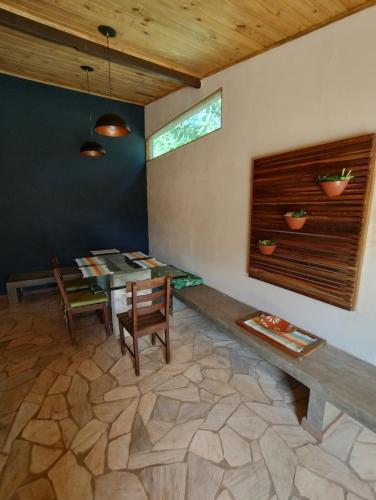a dining room with a table and chairs and a window at Casa Lua in Brumadinho
