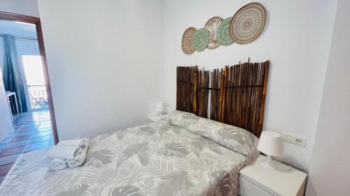 a bedroom with a bed and a mirror on the wall at Apartamento Jimena Cadiz en el centro de Nerja in Nerja