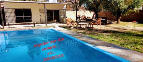 a swimming pool with signs on the side of it at Peperina in Rufino