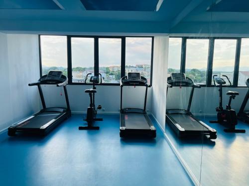 a gym with several treadmills in a room with windows at Olea Vitis in Međugorje