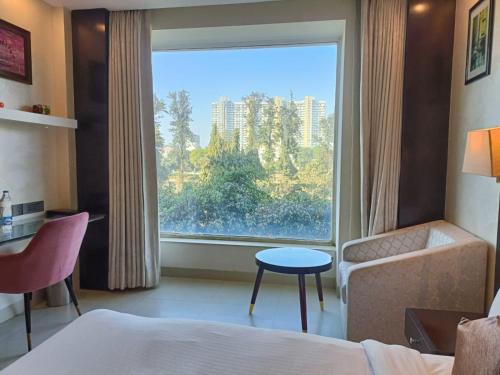 Postel nebo postele na pokoji v ubytování Udman Hotel Chhattarpur