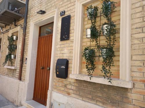 a brick house with plants on the side of it at Dimora50 in Porto Recanati
