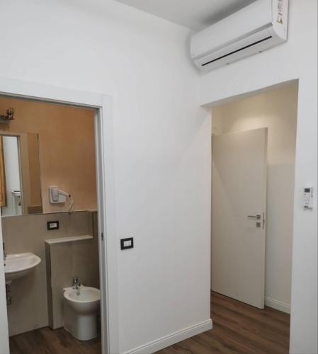 a bathroom with a sink and a toilet and a mirror at Mimi family in Florence