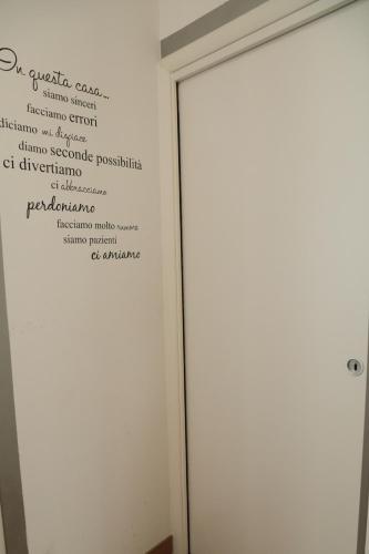 a white door with a sign on the wall at GUEST HOUSE SIMONAZZI in Reggio Emilia
