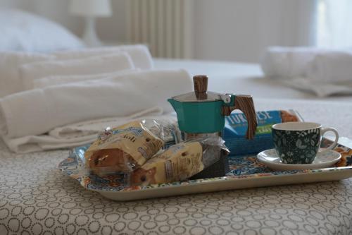 a tray of food and a cup on a table at GUEST HOUSE SIMONAZZI in Reggio Emilia