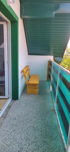 a wooden bench sitting on the side of a house at Apartments Amina Sarajevo in Sarajevo