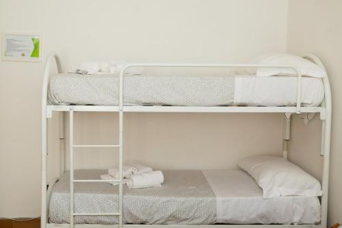 two bunk beds in a small room with a bed at GUEST HOUSE SIMONAZZI in Reggio Emilia
