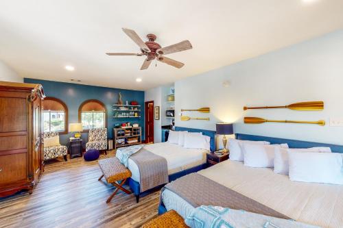 a bedroom with two beds and a ceiling fan at Abruzzi - Villa C in Eatonton 