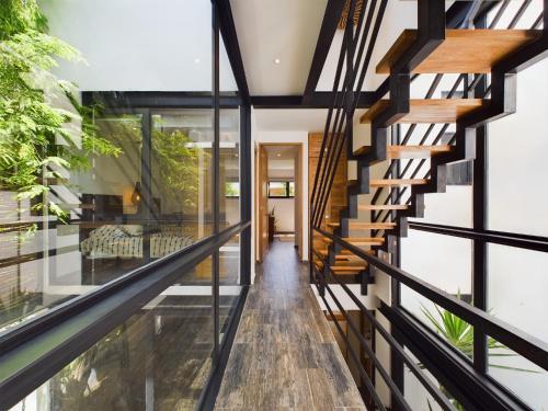 a view of the hallway of a house with a glass wall at Casa Kuaan Mani TH 1 in Tulum