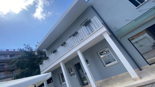 a view of a house with a balcony at Grey House Guest House Luxury in Latina