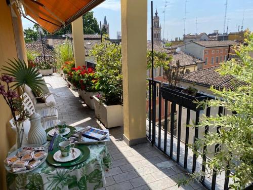 a table with plates of food on a balcony at Le Tre Torri in Parma