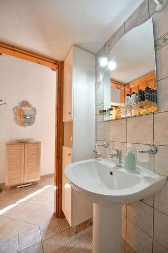 a bathroom with a sink and a mirror at Margarita's House in Hydra