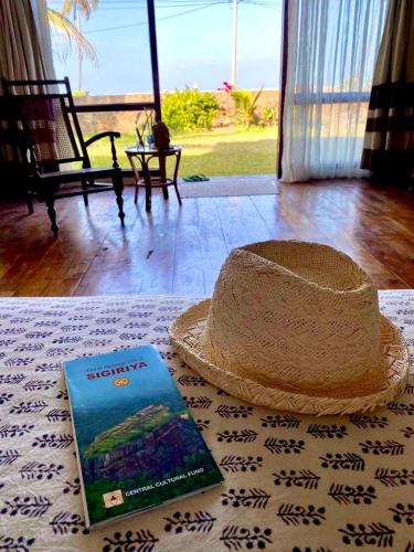 a book and a hat sitting on a table at Spice of Ceylon in Chilaw